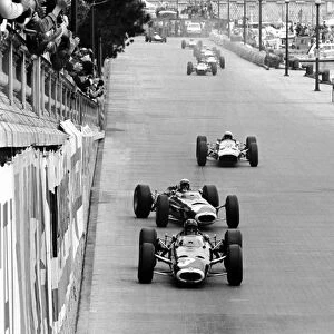 Formula One World Championship: Lap 1: Winner Graham Hill BRM P261 leads a sideways Jackie Stewart BRM P261 and Lorenzo Bandini(2nd Ferrari 1512