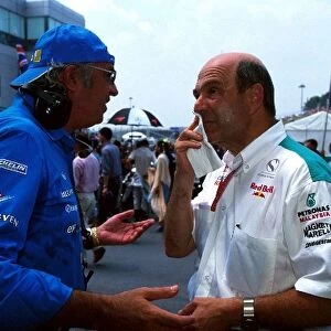 Formula One World Championship: Managing Director of Mild Seven Renault Sport Flavio Briatore talks with Sauber Team Principal Peter Sauber