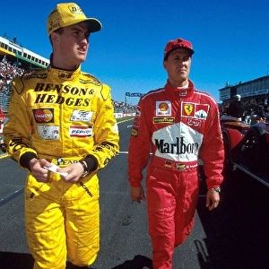 Formula One World Championship: Ralf Schumacher Jordan and his brother Michael Schumacher Ferrari walk down the pitlane
