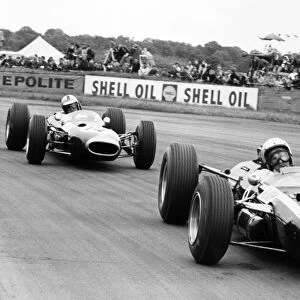 Silverstone, Great Britain. 10 July 1965: Bruce McLaren, Cooper T77-Climax, 10th position, leads Denny Hulme, Brabham BT7-Climax, retired, action