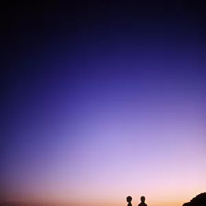 Achill Island, Co Mayo, Ireland; Silhouette Of Children Standing On The Beach Near The Atlantic