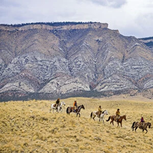 Cowboys and Cowgirls riding horse in wilderness, Rocky Mountain, Wyoming, USA