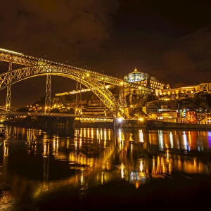 Dom Luis I Bridge crossing River Douro with Vila Nova de Gaia lit up at night, Porto, Portugal