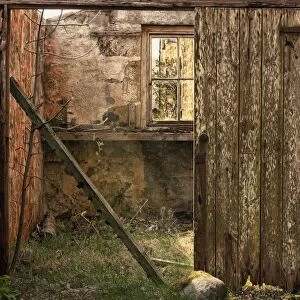 Northumberland, England; An Abandoned Building In Ruins With A Broken Wooden Door