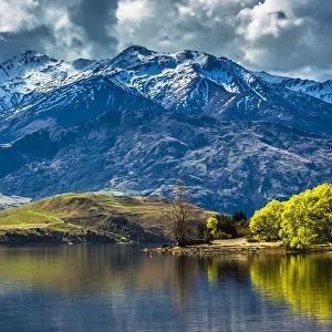 Shoreline of lake and mountain range at Glendhu Bay in the Otago Region of New Zealand