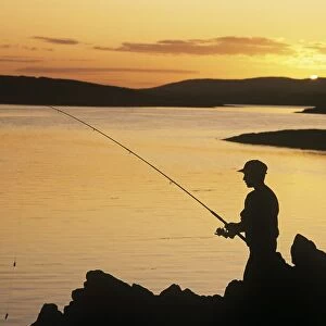 Silhouette Of A Fisherman Fishing On The Coast, Roaring Water Bay, County Cork, Republic Of Ireland