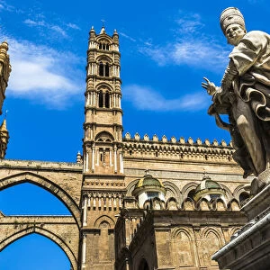 Statue of Archbishop and arcades connecting main building to the palace at the Palermo Cathedral in historic Palermo in Sicily, Italy