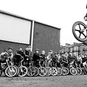 15 year old Martin Brunning in action on a BMX watched by other BMX kids