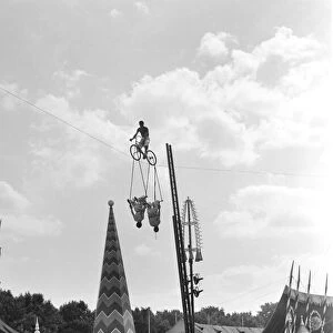 Acrobats and man riding a highrope on a bicycle at Battesea Pleasure Gardens