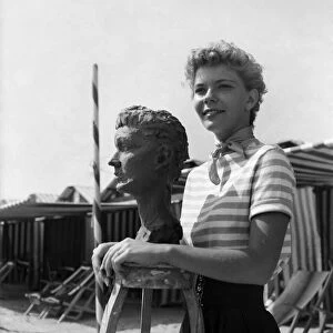 Actress Francis Farmer seen here having bust created on the beach near Venice