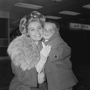 Actress Jill Ireland poses with her young son Paul aged 4 after arriving at London