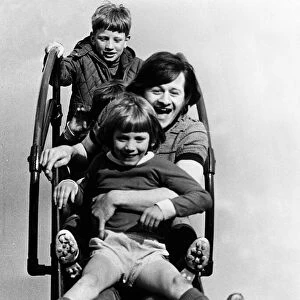Alex Higgins former World Snooker Champion 1983 with two children holding on to