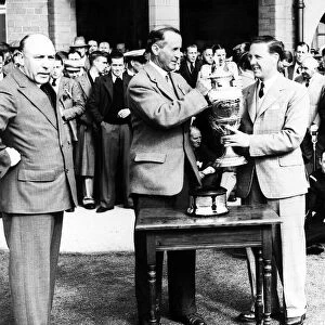 Alex Kyle receiving the amateur golf championship trophy from Mr Glover May 1936