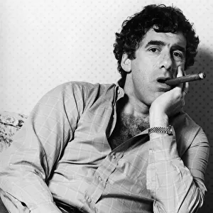 American actor Elliott Gould poses smoking a cigar. January 1984