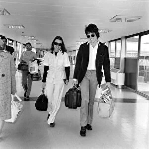 American actor Warren Beatty at Heathrow Airport with Michelle Phillips. May 1975