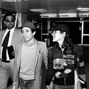 American musician Paul Simon and actress Carrie Fisher at Heathrow airport. 24th May 1980