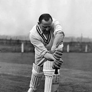 Australian cricketer Cecil Pepper demonstrates a stroke. April 1955