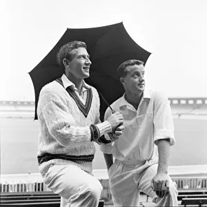 Australian cricketers Graham McKenzie (left) and Grahame Corling take shelter from