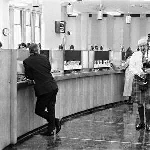 A bagpiper pipes the last day of business of 1970 in the Lloyds banking hall at