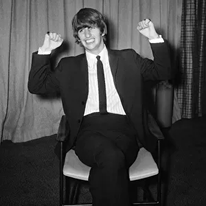 Beatles Files 1963 Ringo Starr sitting on chair, stretching. August 1963