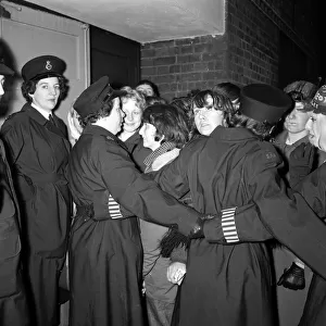 The Beatles November 1963 Policewomen holding back fans with linked arms near