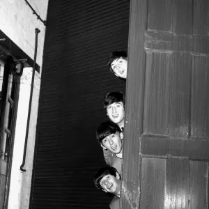 The Beatles peering out from behind a door before the groups appearence at Sunday Night