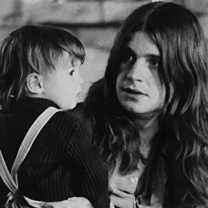 Black Sabbath lead singer Ozzy Osbourne holding his 22 month old daughter Jessica