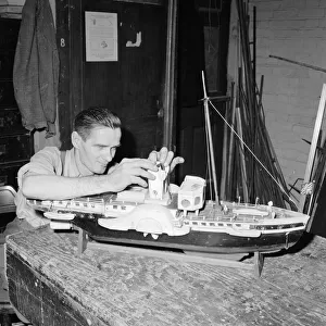 A blind model maker completes his latest model boat Circa 1957
