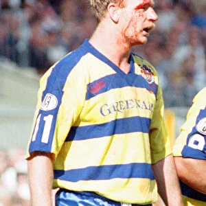 Bloodied Bob Jackson of Warrington is dejected after their defeat by Wigan in the Rugby