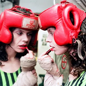 Boxer Pauline Dickson applying lipstick in the changing rooms of her boxing gym