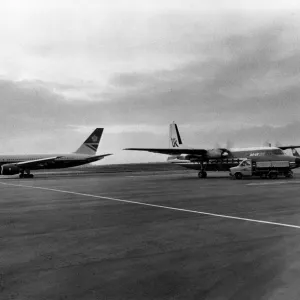 A British Airways 757 taxis past an Air UK Fokker F27 at Heathrow Airport