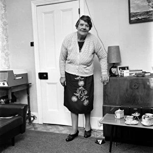 British family feature: A grandmother standing in her living room November 1969