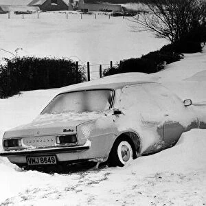 A car is left in a deep snow drift on the road from Culverhouse Cross to St Lythans near