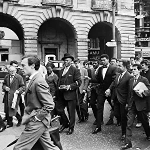 Cassius Clay and entourage walking through Regent Street on route to his press conference