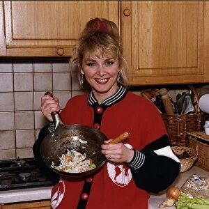 Cheryl Baker former Bucks Fizz singer and TV presenter cooking a stir fry in her kitchen