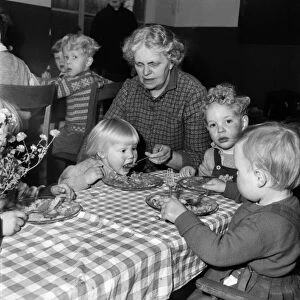 Children eating dinner at the table at a day nursery in Leeds November 1952