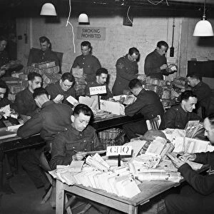Clerks at work in an Army Post Office dealing with letters