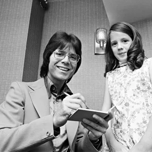 Cliff Richard signing autograph for a young fan, he is starring in Take Me High