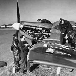 A clipped wing Spitfire of the Royal Air Force being serviced at a Fighter Command