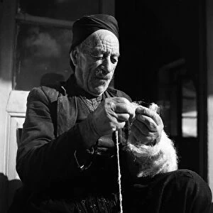 Closeup of man making string in Cyprus town. November 1952 C1103-001