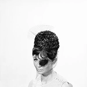Clothing: Fashion: Hats: Woman wearing hats with veils and eyepatch. 1962 B1544-031