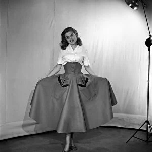 Clothing: Fashion: Skirts model wearing felt skirt. October 1953 D5999