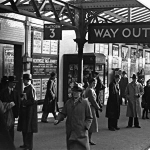 Commuters and schoolchildren on platform three of Kingston Station await the next train