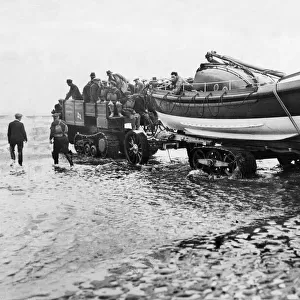The crew of the RNLB Oldham wheel the lifeboat down the beach at Hoylake Lifeboat Station