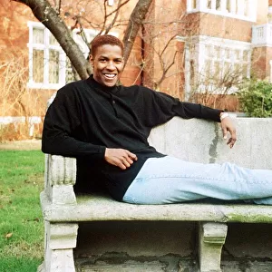 Denzel Washington Actor sitting on a bench