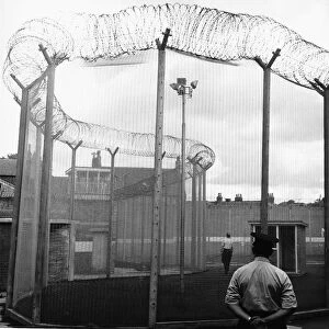 Durham Prison security wing a man in the exercise cage at Durham jail watched by a warder