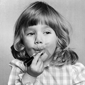 Emma Varsanyi. March 1976 P034769 Little girl putting on lipstick