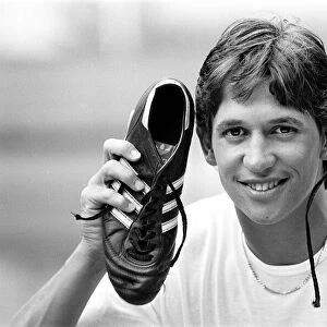 England footballer Gary Lineker shows off his shooting boots at the team base in