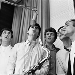 The English pop rock group, Dave Clark Five singing in a recording studio