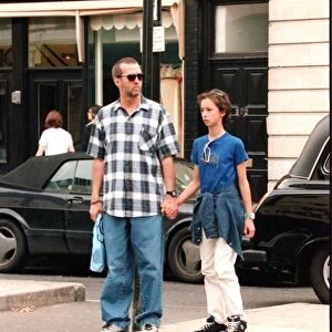 Eric Clapton musician and his daughter hold hands as they shop in the Kings Road London